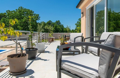 Kozljani House | Enjoy a relaxing time in this modern vacation home with pool.