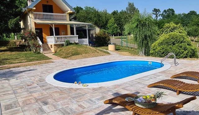 Country house with swimming pool surrounded by pure nature