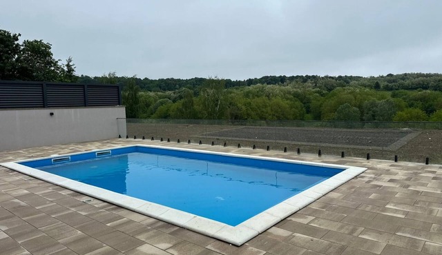 Modern villa with pool, jacuzzi, and sauna for relaxation and family getaway.